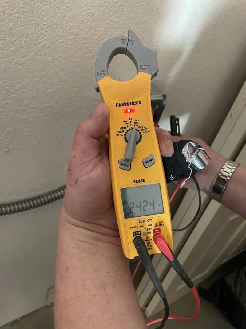 Voltage testing with clamp meter during Outlet Installation in East Cleveland